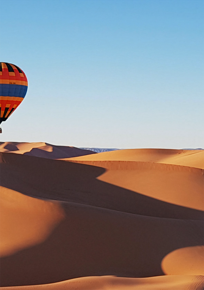 Vibrant Hot Air Balloons Over Desert Landscape Art Print