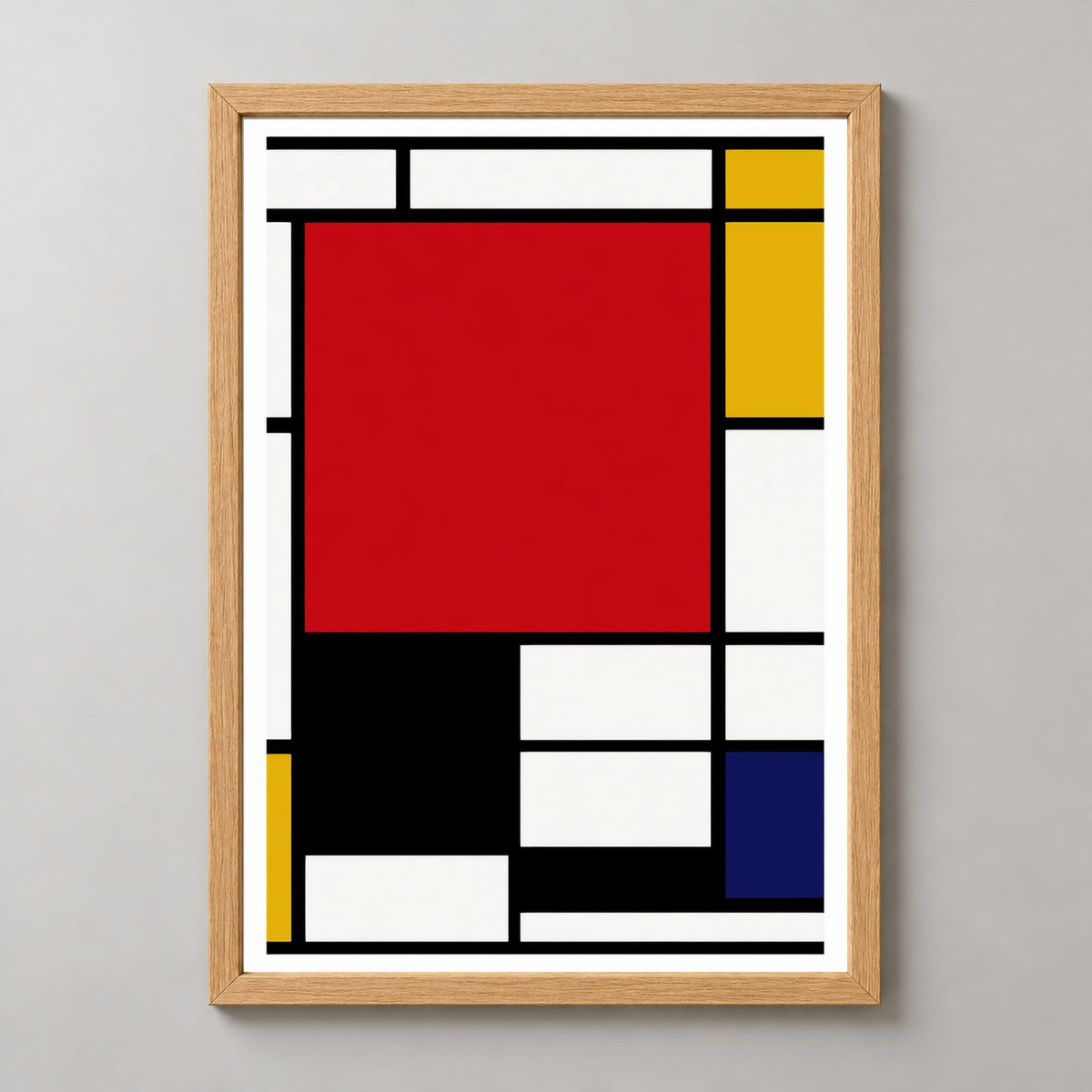 Piet Mondrian composition artwork print with large red pane, yellow, black and blue — realistic natural wood frame studio view