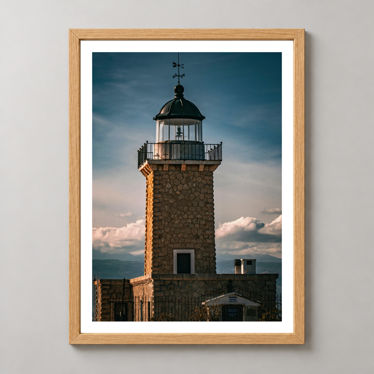 Majestic Lighthouse at Dusk - Captivating Coastal Art Print — realistic natural wood frame studio view with white border