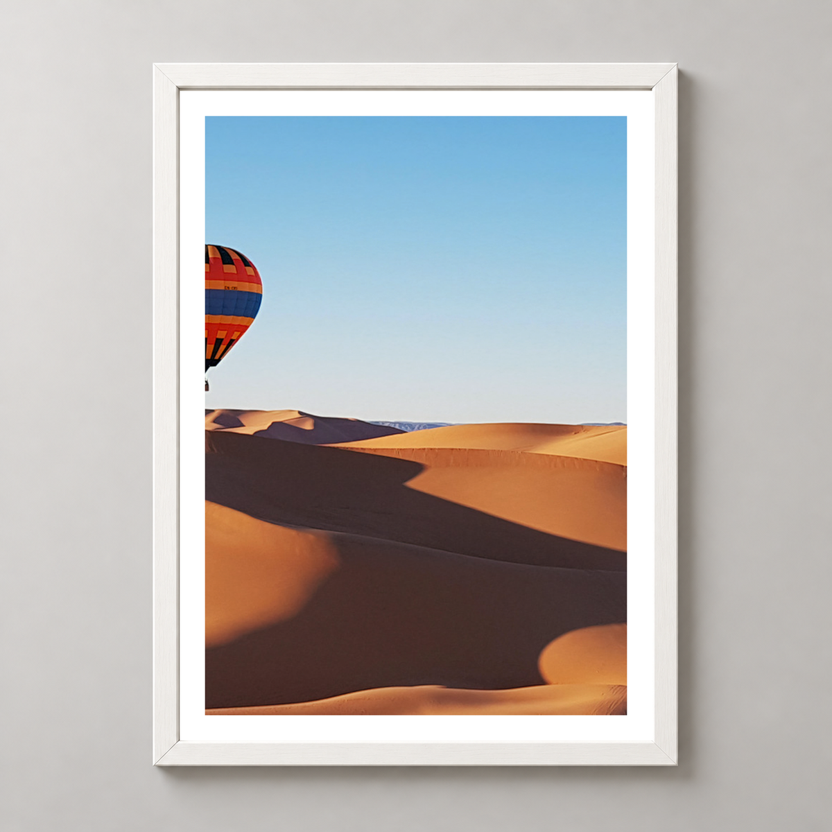 Vibrant Hot Air Balloons Over Desert Landscape Art Print — realistic white frame studio view with white border