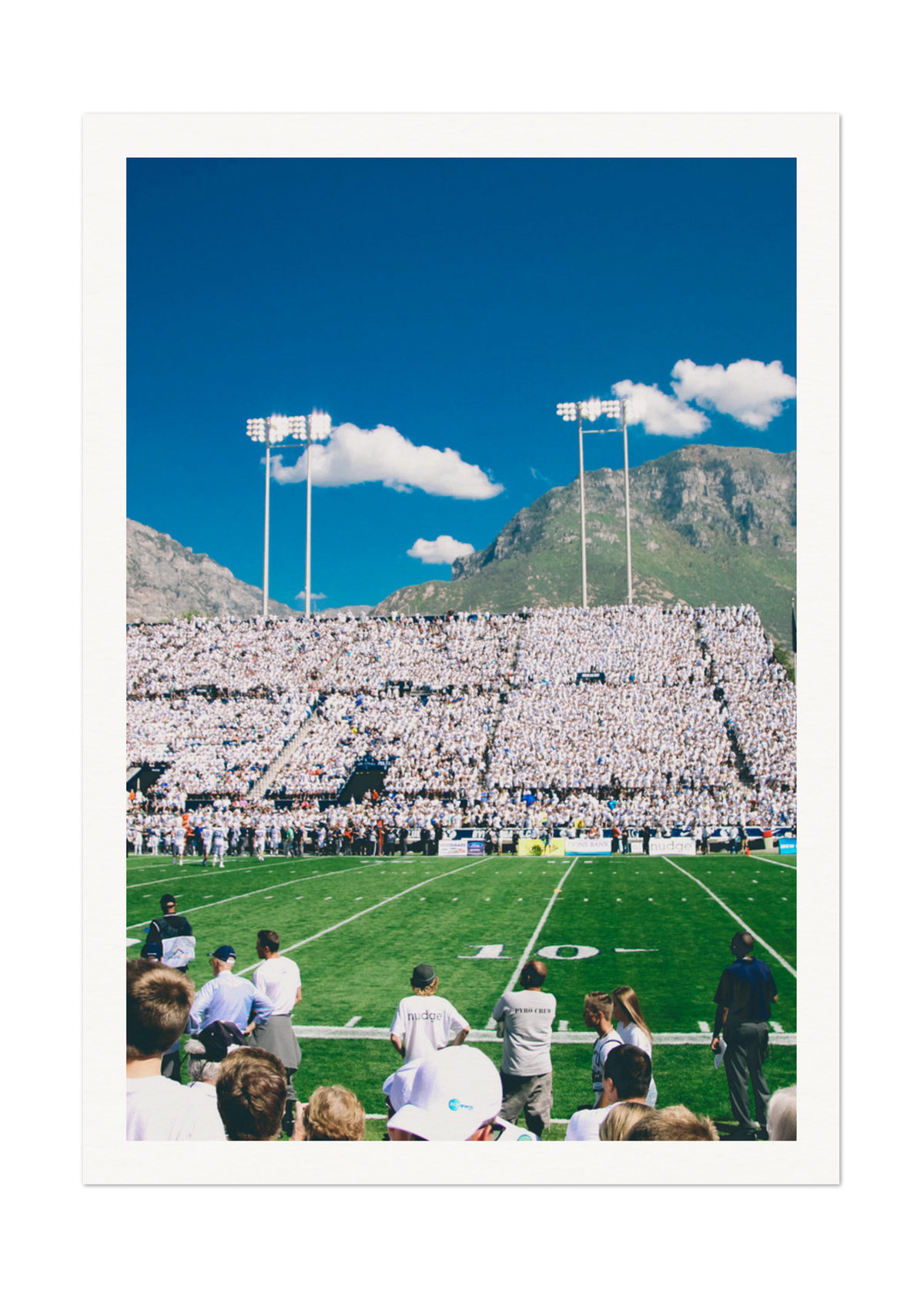 Vibrant Football Stadium with Mountain Backdrop - High-Quality Print