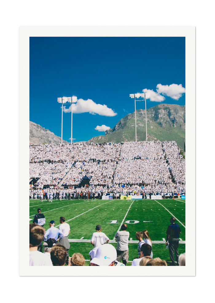 Vibrant Football Stadium with Mountain Backdrop - High-Quality Print