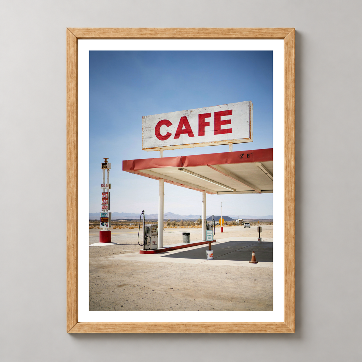 Retro Desert Cafe and Gas Station Art Print — realistic natural wood frame studio view with white border