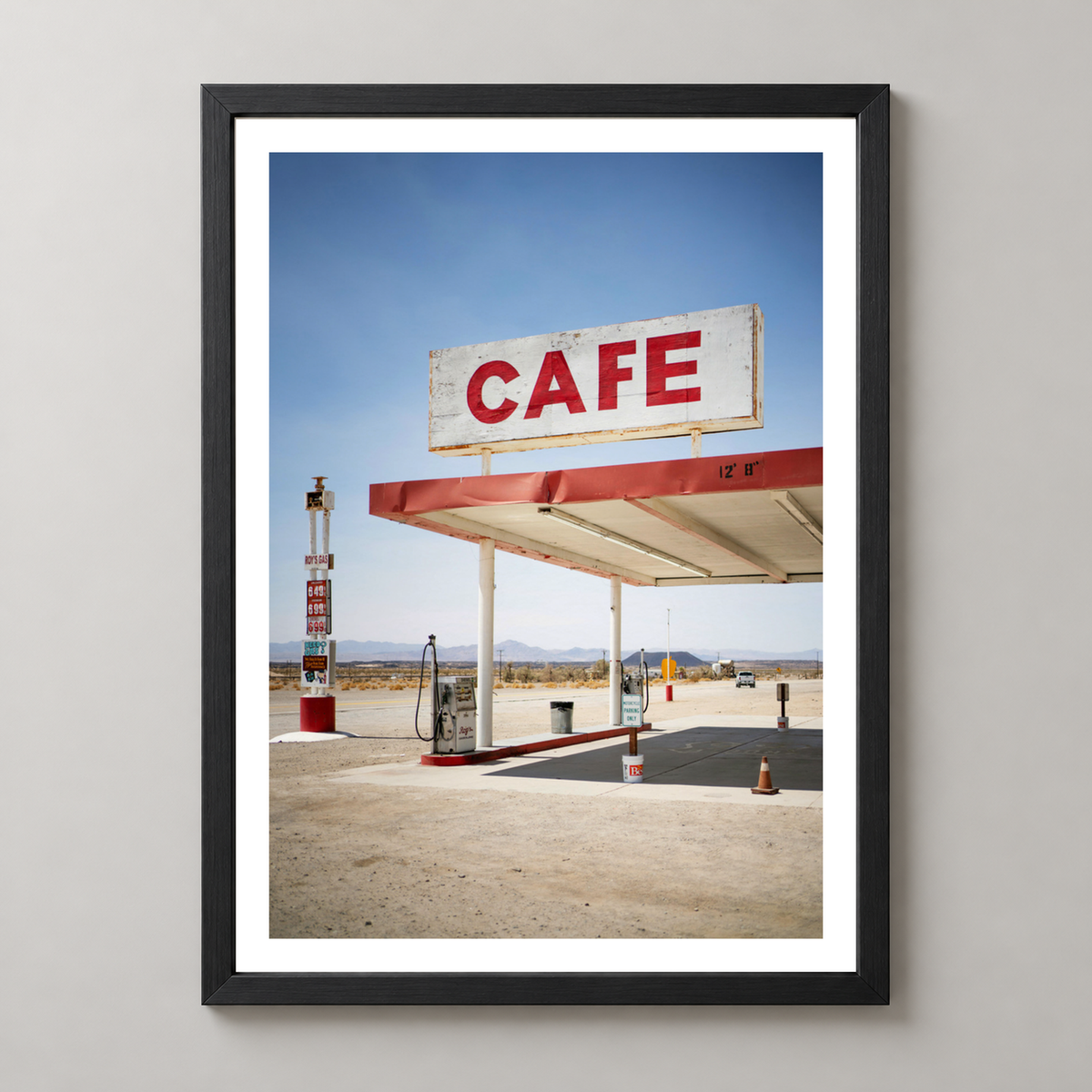Retro Desert Cafe and Gas Station Art Print — realistic black frame studio view with white border