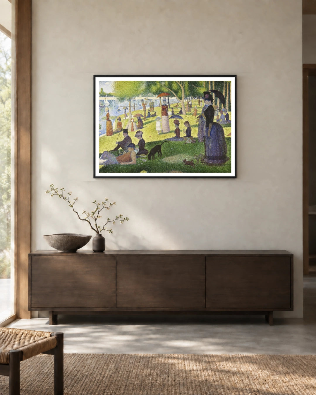 A Sunday on La Grande Jatte Art Print by Georges Seurat in a black frame; styled landscape setting.