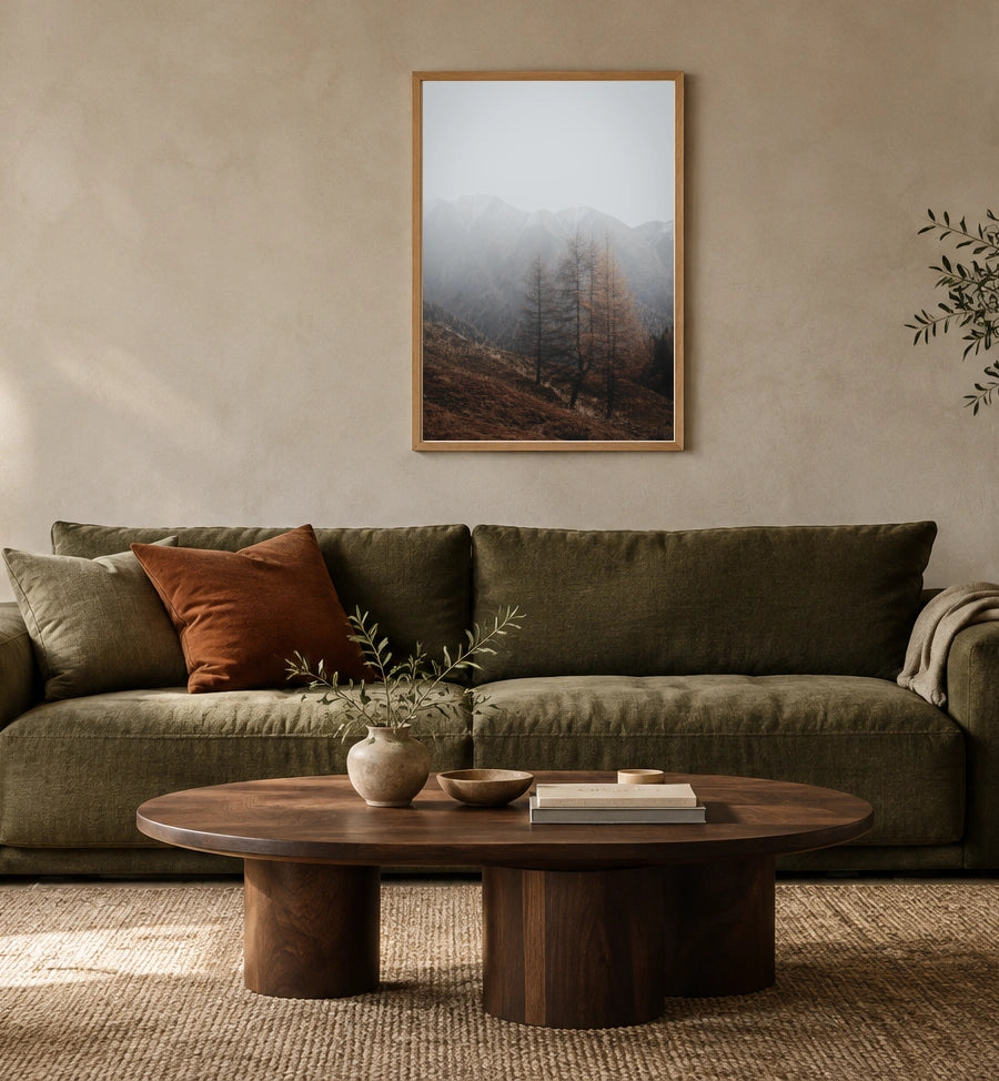 Autumn Mist in a natural wood frame above an olive sofa; styled living-room mockup