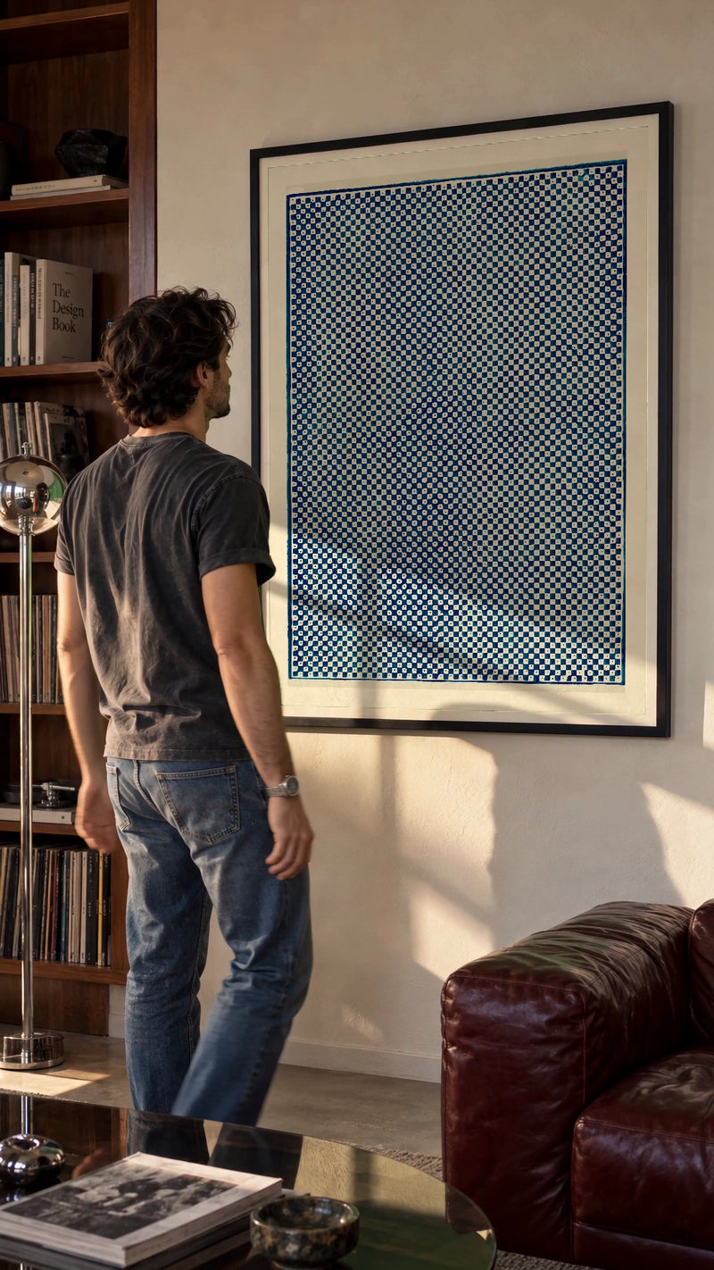 Blue Checkerboard in a black frame being hung on a wall; styled scene