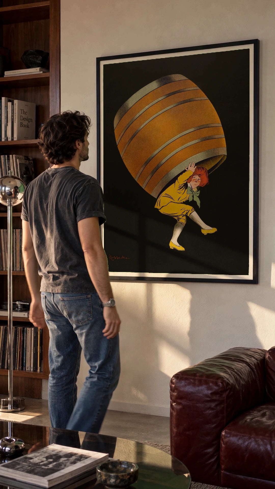 Cognac Pellisson in a black frame being hung on a wall; styled scene