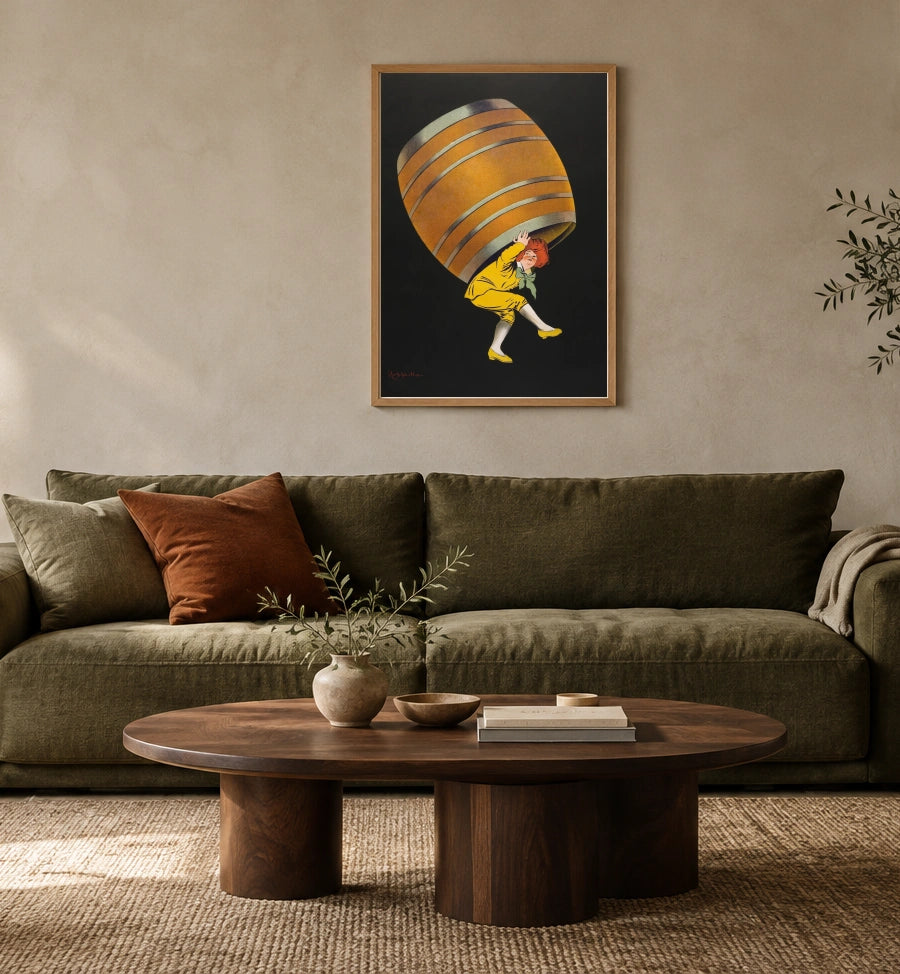 Cognac Pellisson in a natural wood frame above an olive sofa; styled living-room mockup