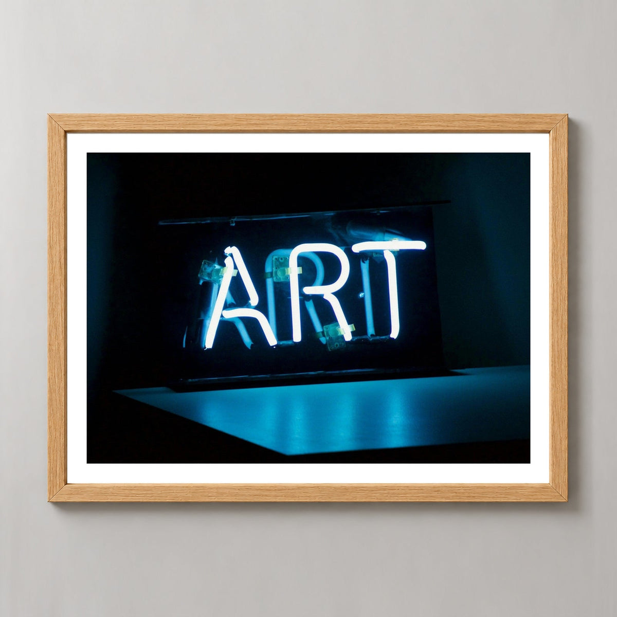 Art in Neon — realistic natural wood frame studio view with white border