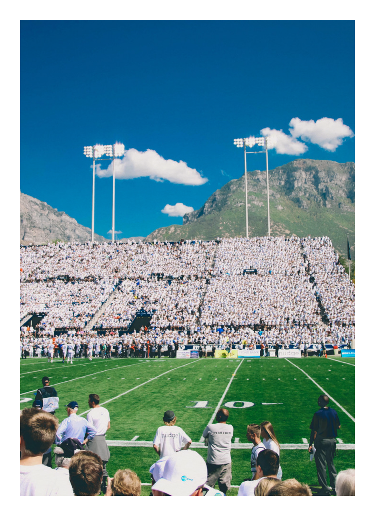 Vibrant Football Stadium with Mountain Backdrop - High-Quality Print — poster only, complete unframed artwork with white border