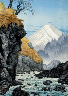 Foot of Mount Ashitaka Art Print by Hiroaki Takahashi. A rocky stream leads the eye towards a snow-covered mountain beneath a clear blue sky