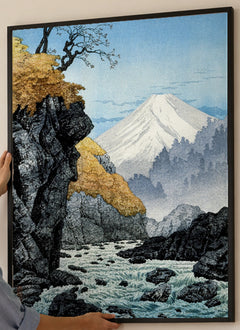 Foot of Mount Ashitaka Art Print by Hiroaki Takahashi in a black frame; close-up of the framed artwork.