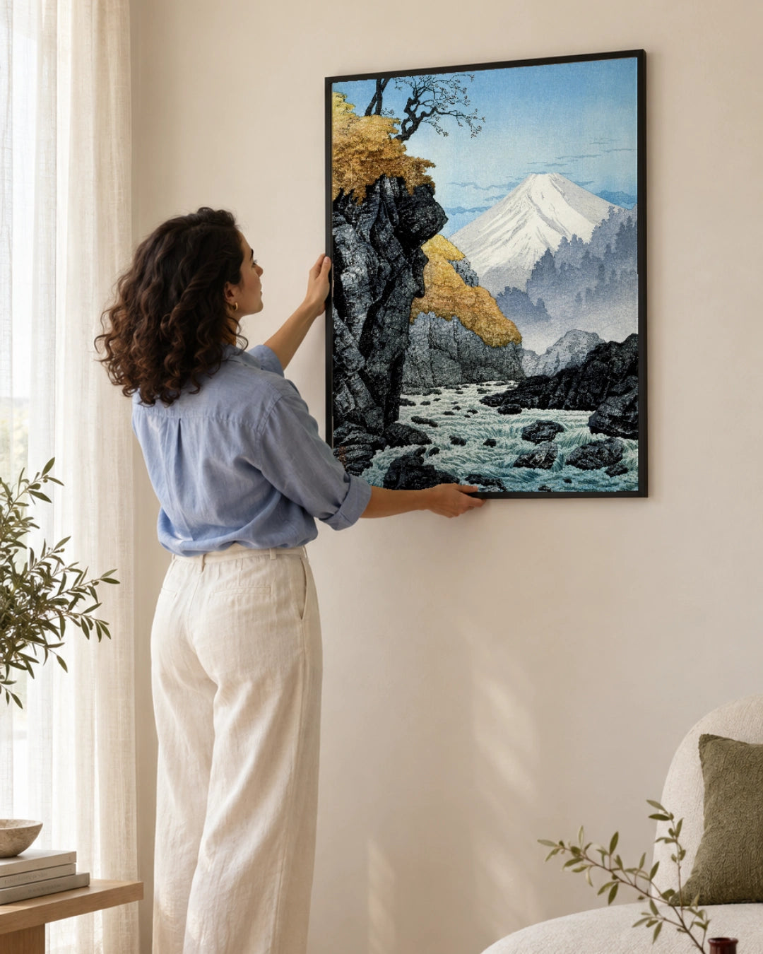 Foot of Mount Ashitaka Art Print by Hiroaki Takahashi in a black frame; styled woman setting.