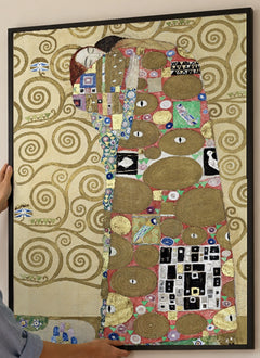 Fulfillment Art Print by Gustav Klimt in a black frame; close-up of the framed artwork.
