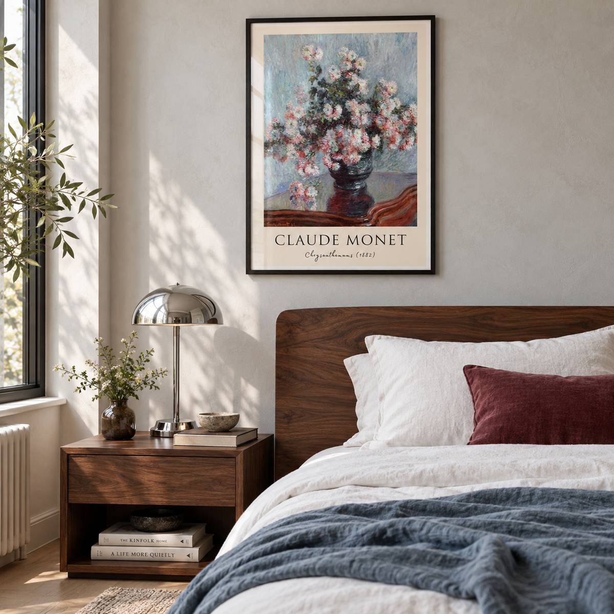 Monet Chrysanthemums print in a black frame above a walnut bed with white linen and blue and burgundy accents