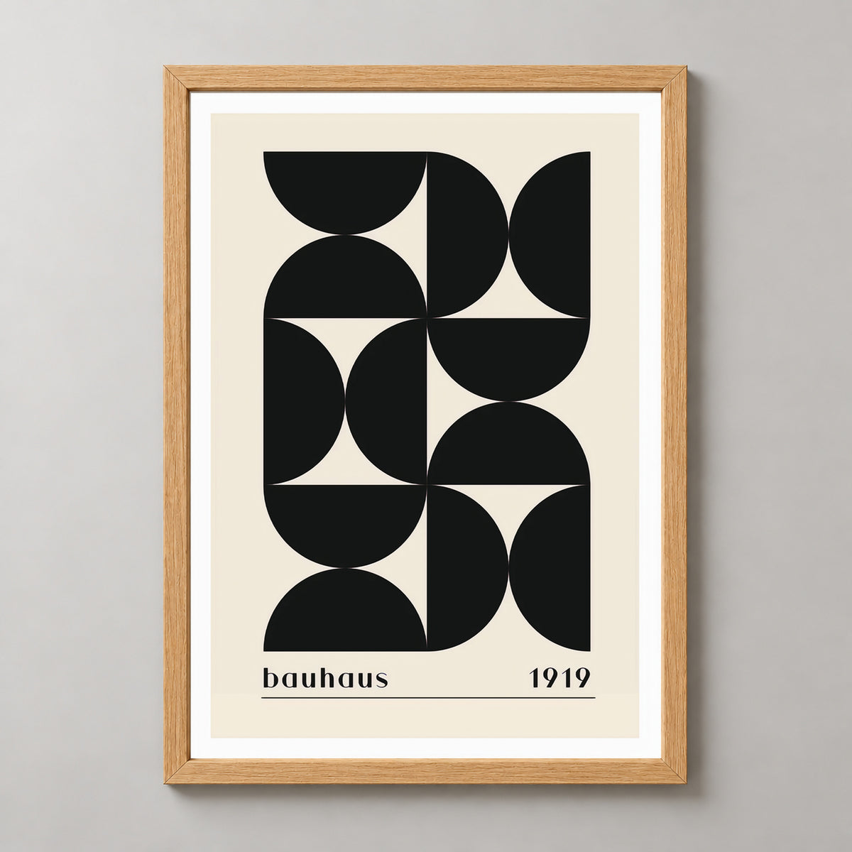 Bauhaus 1919 - Minimalist Geometric Art Print (Black) — realistic natural wood frame studio view