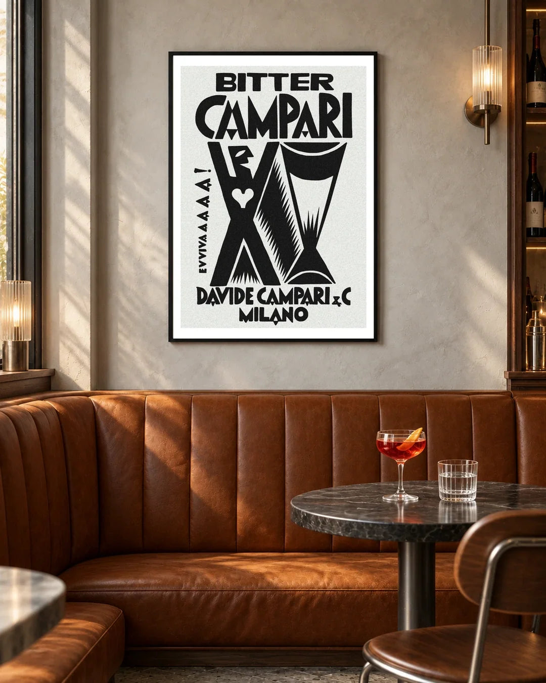 Bitter Campari Evviva Black and White Poster — black frame in a contemporary bar with grey walls and tan leather seating