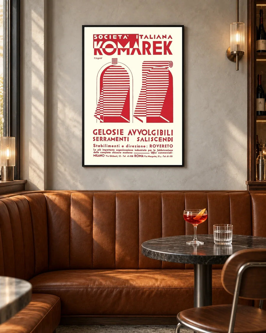 Komarek Italian Advertising Poster by Fortunato Depero — black frame in a contemporary bar with grey walls and tan leather seating