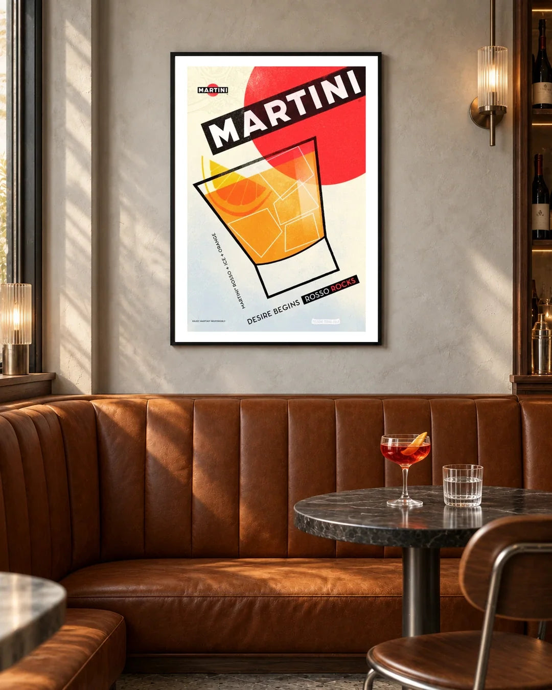 Martini Rosso Rocks Glass Poster — black frame in a contemporary bar with grey walls and tan leather seating