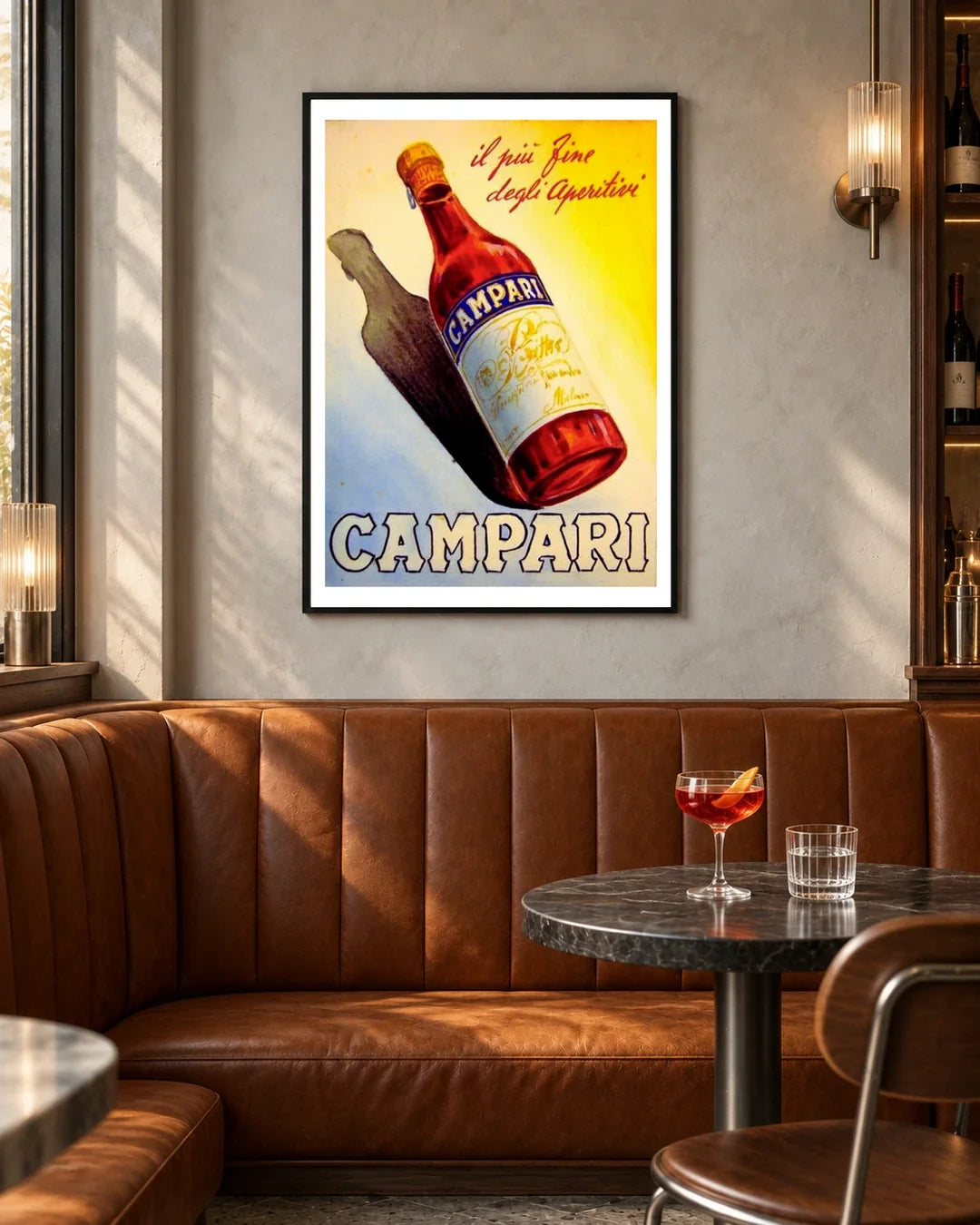 Campari Aperitif Bottle and Shadow Poster — black frame in a contemporary bar with grey walls and tan leather seating