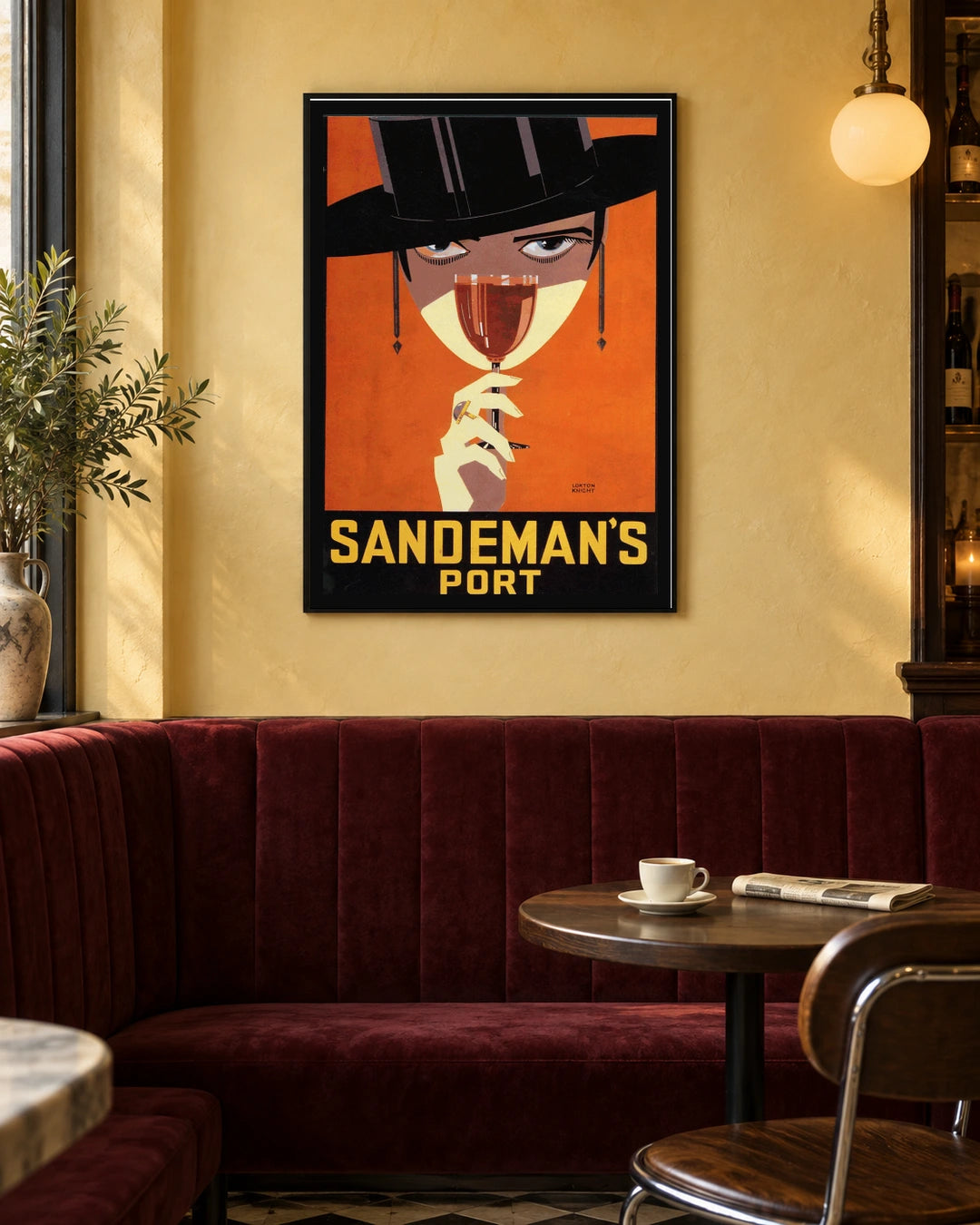 Sandeman's Port Woman in Black Hat Poster — black frame in a warm bistro dining space