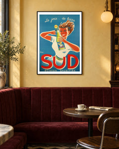 Sud La Joie de Boire Soda Poster — black frame in a warm bistro dining space