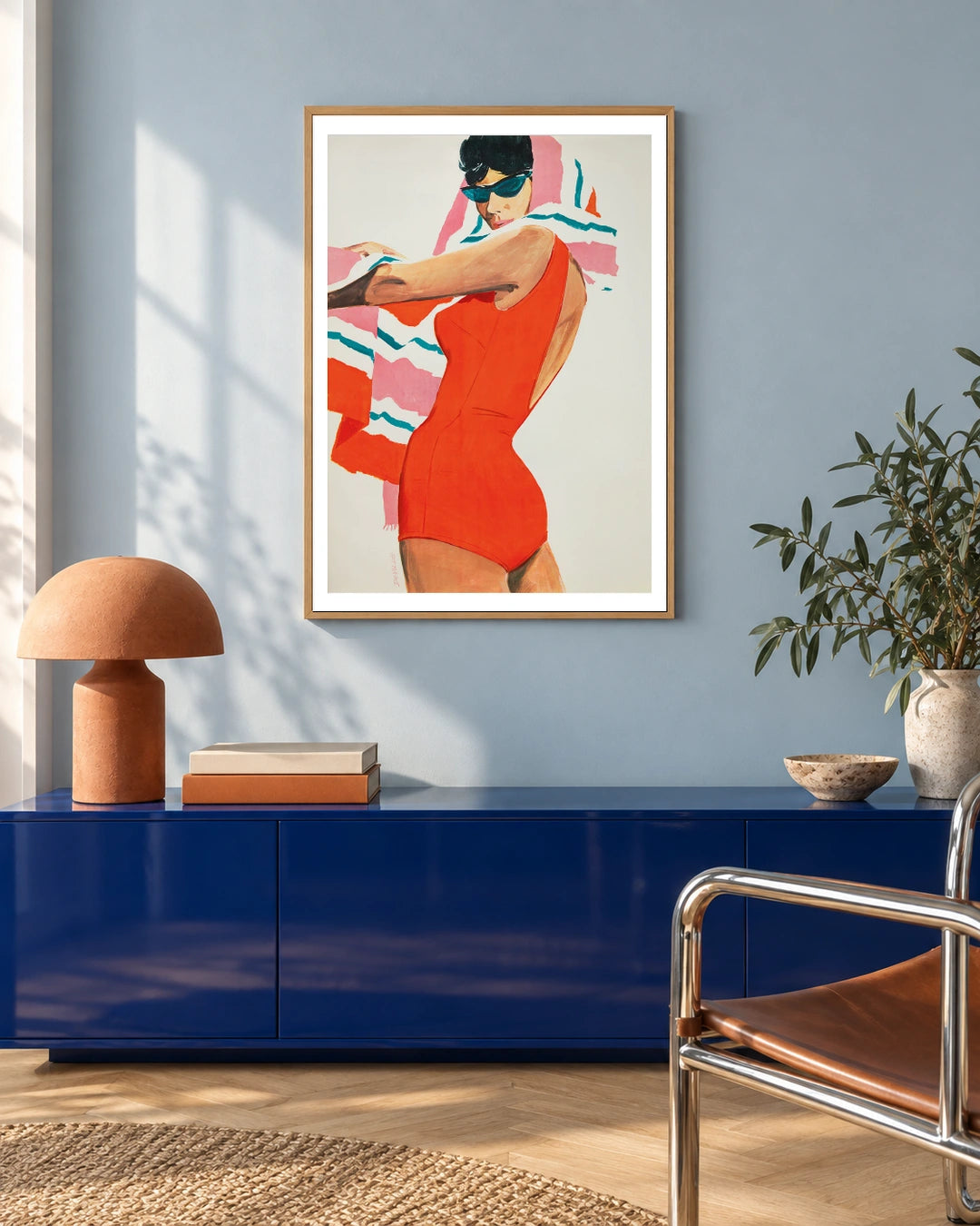Lahco Red Swimsuit Poster — natural wood frame in a blue-toned living space