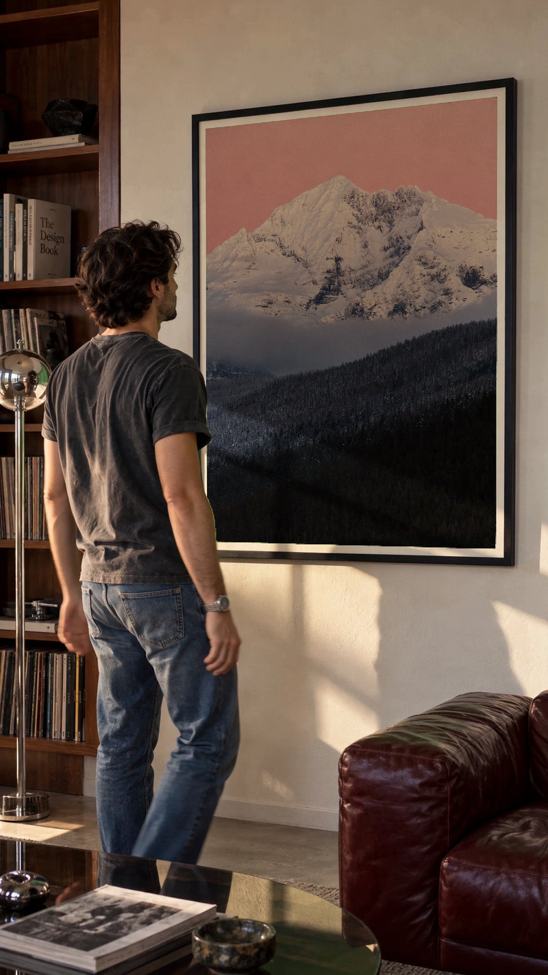 Gunsight Mountain at Dusk in a black frame being hung on a wall; styled scene