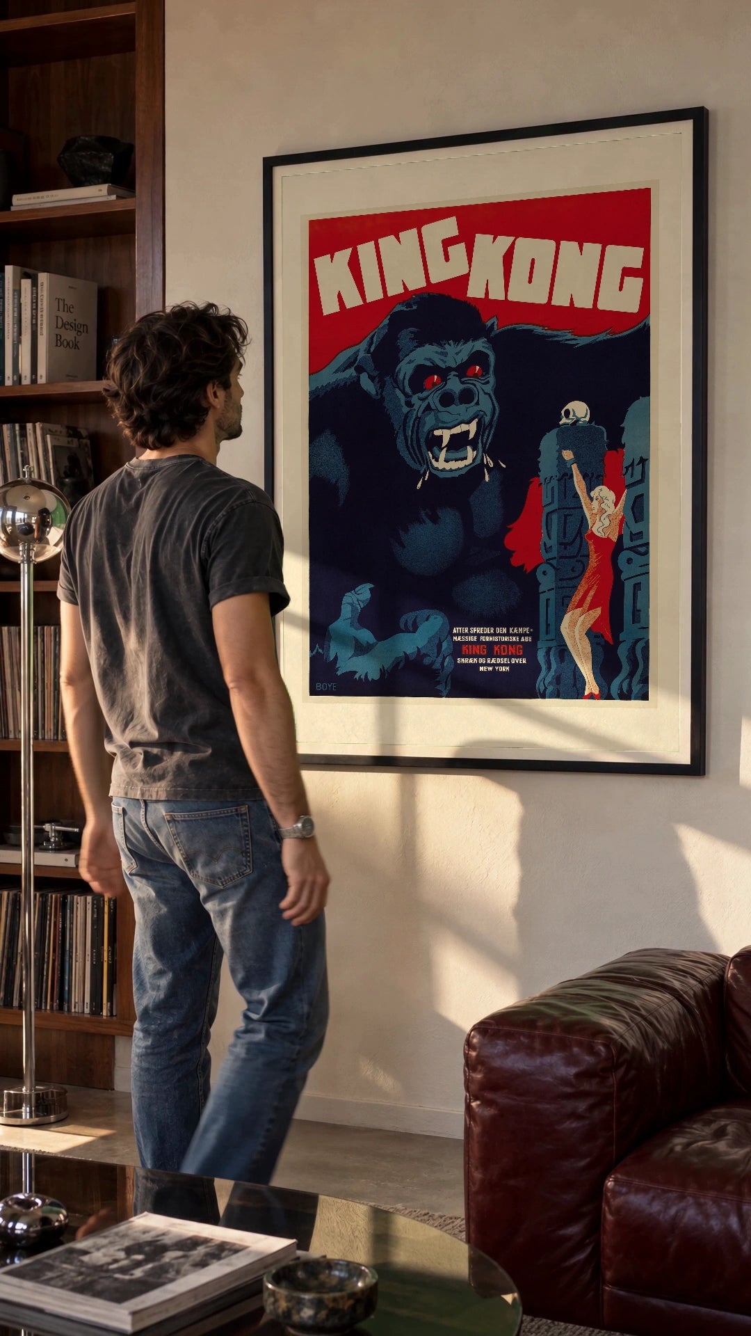 King Kong — Danish Poster in a black frame being hung on a wall; styled scene