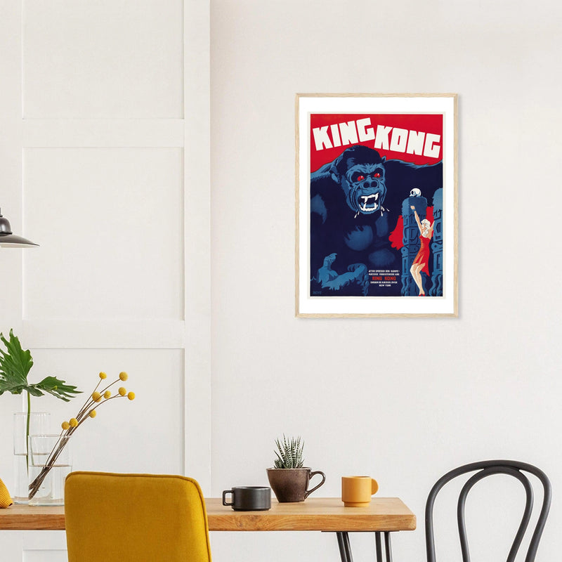 King Kong — Danish Poster in a natural wood frame above a dining table; styled room mockup