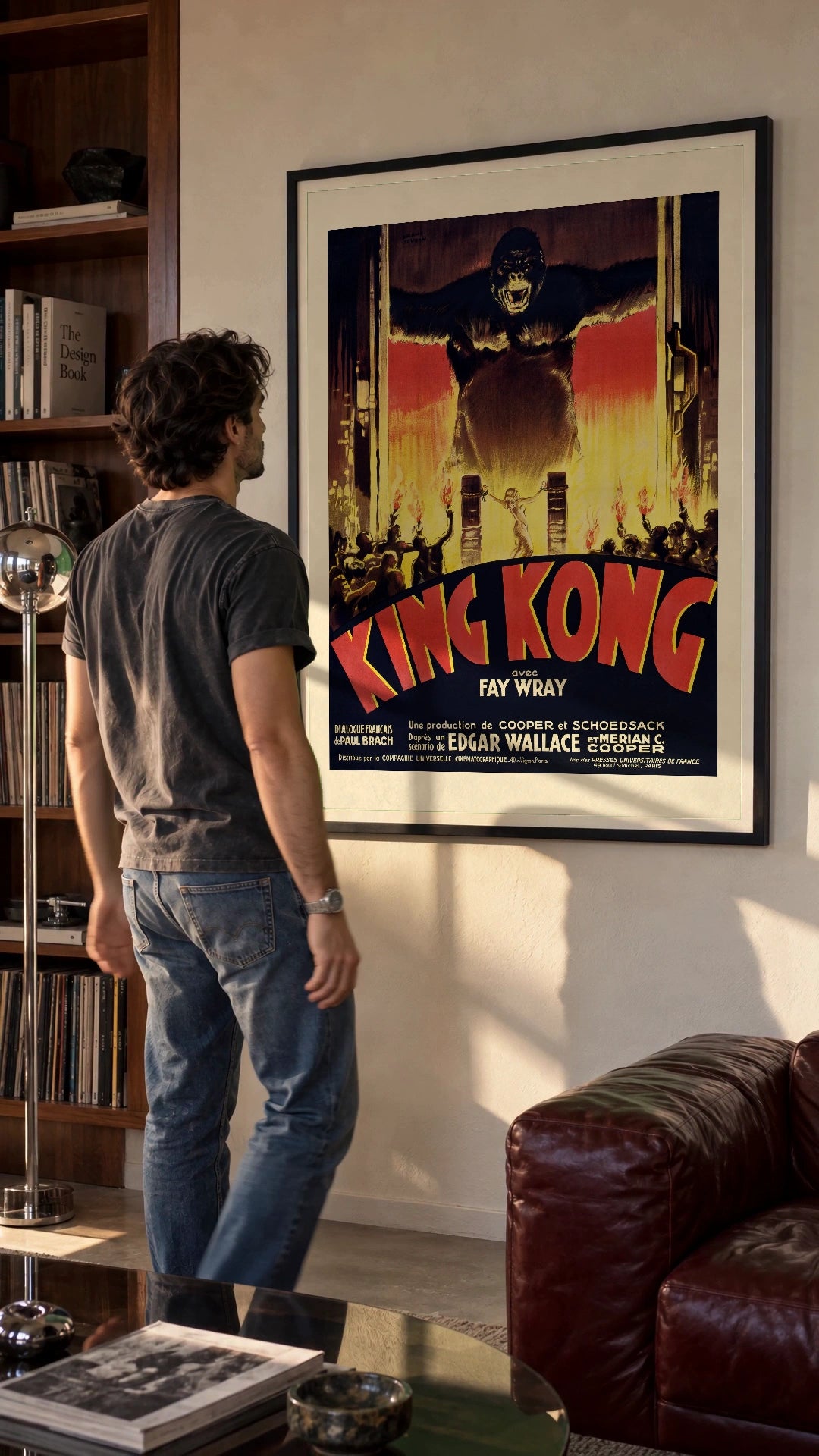 King Kong — French Poster in a black frame being hung on a wall; styled scene