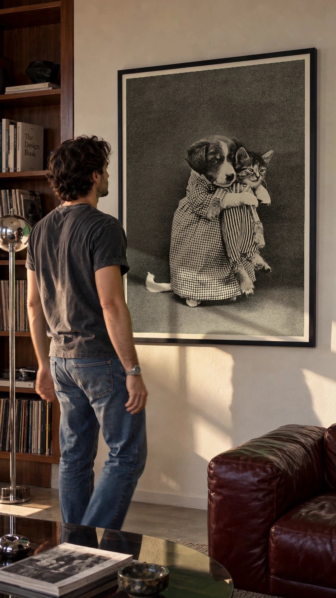 Miss Kindeyes in a black frame being hung on a wall; styled scene
