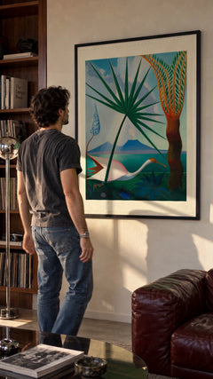 Neapolitan Song in a black frame being hung on a wall; styled scene