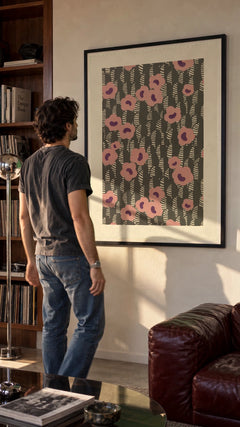 Sidewall — Pink Flowers in a black frame being hung on a wall; styled scene