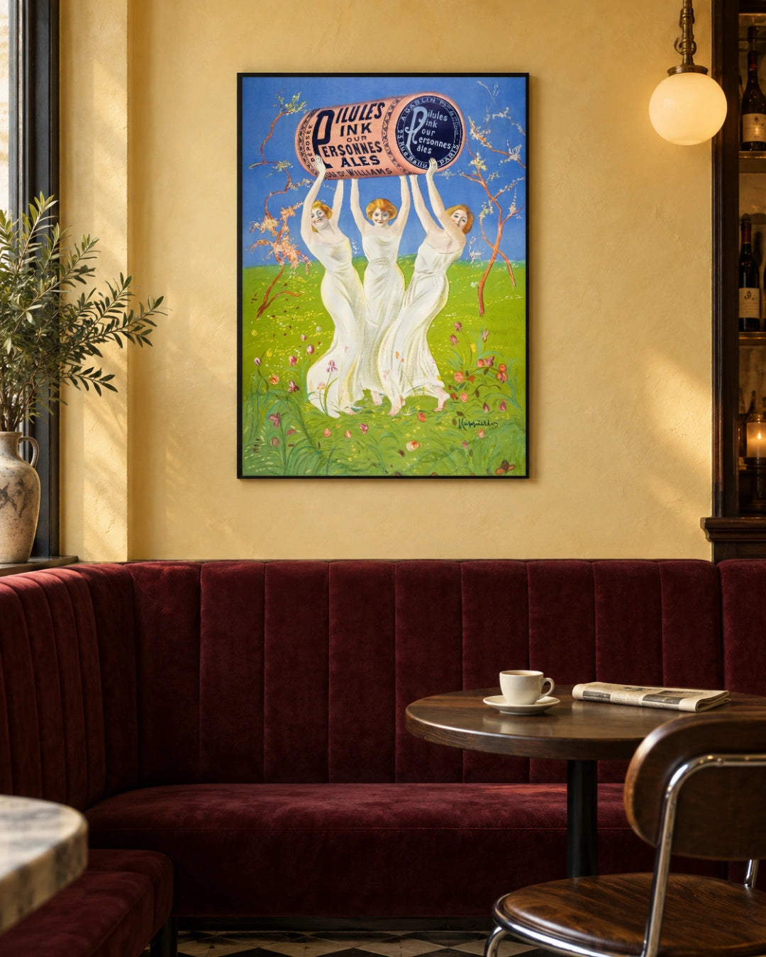 Pink Pills for Pale People Art Print by Leonetto Cappiello in a black frame; styled bistro setting.