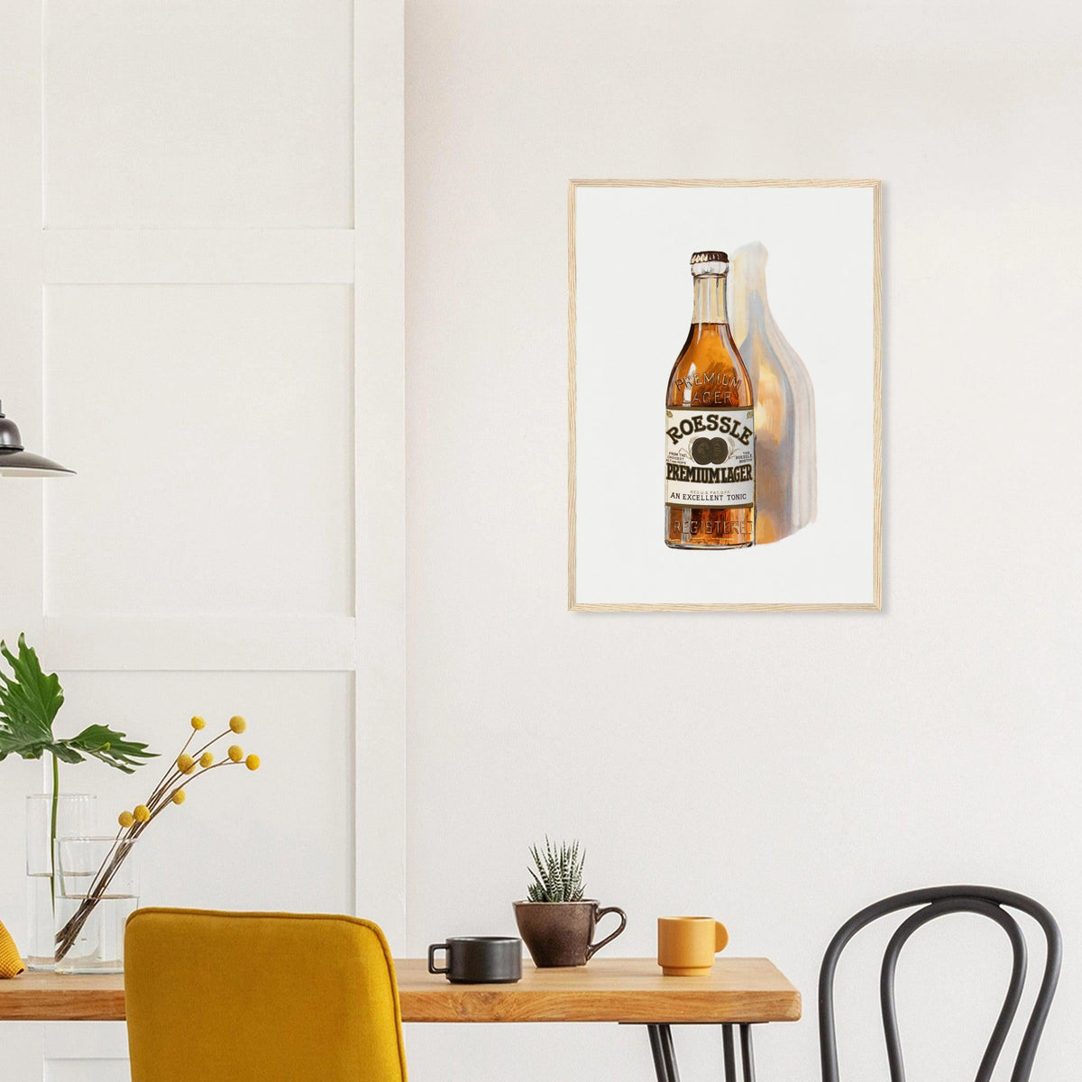 Roessle Premium Lager poster in a natural wood frame above a dining table; styled room mockup