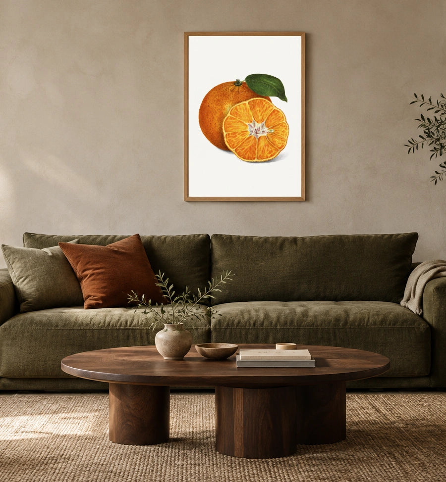 Tangerine Study in a natural wood frame above an olive sofa; styled living-room mockup